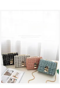 Detail of tweed wool mini bags in four colors with gold chain straps and metal locks