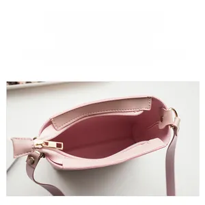 Detailed interior view of a pink mini crossbody bag with zipper and spacious compartment