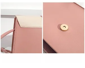 Detail of pink and beige leather stitching with polished gold magnetic buckle