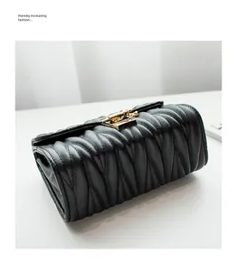 Close-up of black matelassé quilted leather bag with elegant golden metal lock detail