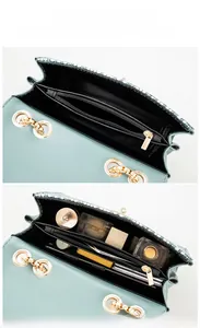 Detail view of the interior compartment and zip pocket of this stylish crossbody bag