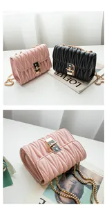 Detail of pleated chain crossbody bag with golden twist lock in pink and black