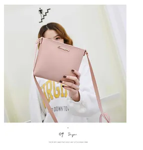 Detail of light pink PU leather crossbody bag with golden Sunnycity logo and slim strap