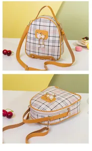 Detail of plaid mini crossbody bag with cat metal piece and pearl tassel charms