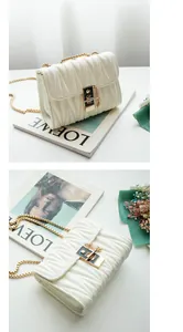 Detail of white pleated quilted flap bag with gold chain strap and square buckle clasp