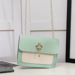 Mini pastel green crossbody bag with gold crown pendant and chain strap for women