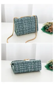 Detail of blue tweed shoulder bag showing gold metal chain strap and side gusset design