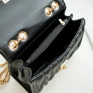 Black quilted flap shoulder bag with three compartments and gold-tone metal chain and lock