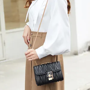 Elegant black quilted crossbody bag with gold chain strap and stylish pleated PU leather