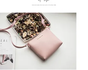 Detail of light pink PU leather mini square crossbody bag with gold metallic logo detail