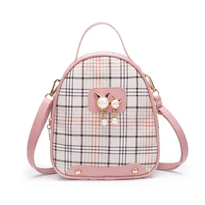 Pink checkered crossbody backpack with pearl charm and cat-shaped metal gold ornament