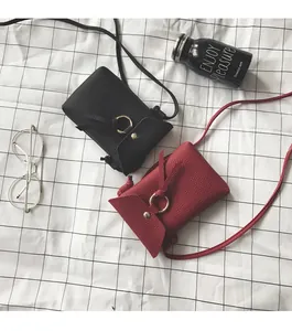 Détail de mini sacs bandoulière pour téléphone en noir et rouge avec anneau doré élégant