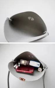 Detail view of small square bag interior with magnetic closure and daily essentials