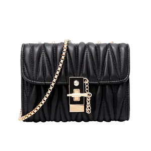 Elegant black quilted chain bag for women with gold metal lock and pleat texture