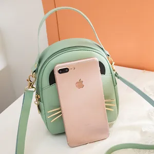 Mint green cat ear mini crossbody bag made of synthetic leather with gold whiskers decor