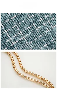 Detailed view of blue woven fabric texture and golden square link chain strap of the bag