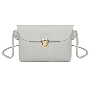 Light grey minimalist crossbody square bag with a golden metallic clasp and slim strap