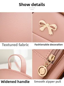 Detalle del bolso de cuero rosa con lazo dorado, asa ancha y cremallera resistente