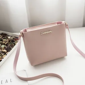 Pink minimalist faux leather crossbody bag with golden Sunrupity logo and strap