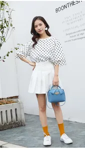 Litchi pattern crossbody bag with bee buckle shown in a lifestyle street style outfit
