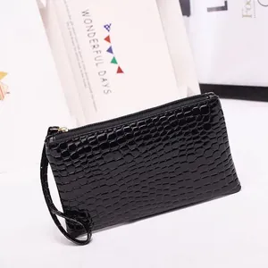 Classic black crocodile pattern clutch bag with gold zipper and wristlet strap