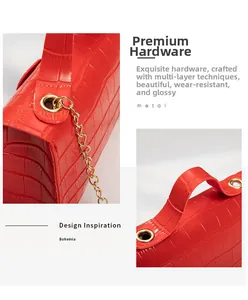 Detailed macro view of red crocodile pattern leather with premium gold metal chain handle