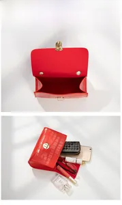 Detail view of red crocodile pattern handbag showing spacious interior for essentials