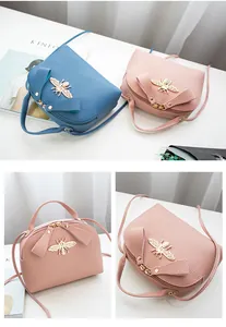 Close-up of litchi texture PU leather handbag with gold bee buckle and double zippers