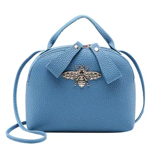 Blue lychee pattern shell bag with golden bee accessory and adjustable strap