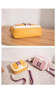 Detailed close-up of colorful litchi pattern leather camera bags with striped straps