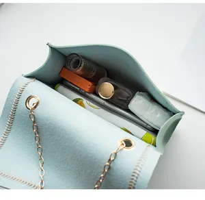Internal view of mint green crossbody bag showing space for phone and makeup
