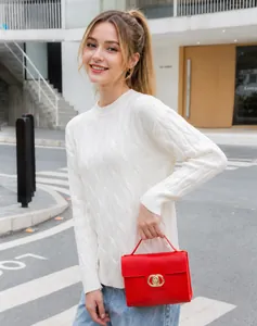 Detailed view of women's red leather chain bag with gold double-ring clasp buckle