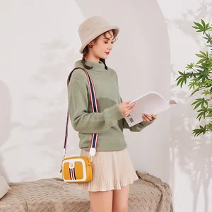 Fashionable yellow camera bag with tri-color ribbon and adjustable wide striped strap