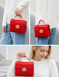 Detail of red croc-embossed small square bag with iconic golden double ring lock