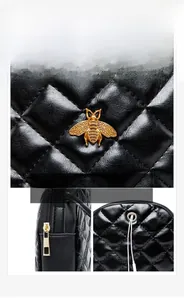 Detail of black quilted leather mini bag with golden bee buckle and headphone port