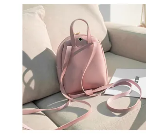 Pink mini PU leather backpack detail with top handle and adjustable shoulder straps