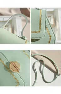 Detailed close-up of mint green bag showing hexagonal lock, stitching and hardware texture