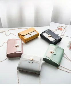 Detail view of five assorted colorful crossbody bags with metal chains and flip-top locks