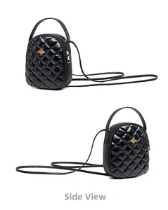 Side view of black quilted mini bag featuring golden bee emblem and glossy finish