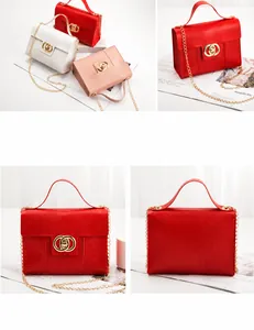 Detail view of lizard embossed square bags with gold double-ring locks and chain straps