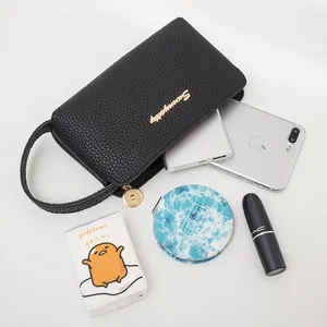 Black pebble leather wristlet clutch bag with gold zipper and metal logo for women