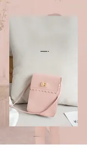Detail of light pink mini phone bag featuring scalloped trim and gold swivel lock