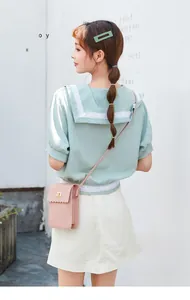 Detail of pink flap crossbody phone bag with scalloped edges and gold square clasp lock