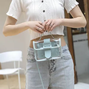 Mini transparent PVC handbag with light blue leather insert and crossbody strap worn by model