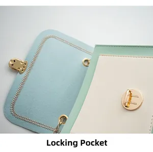 Detail view of the gold lock closure and blue felt lining of a color-block handbag