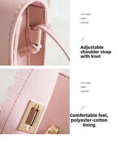 Detail of pink PU leather handbag showing knot-fixed strap and golden metal twist lock