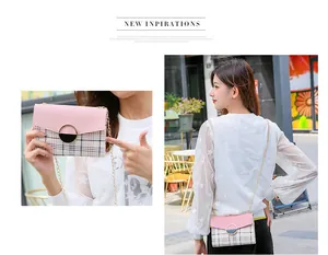 Detail of pink and plaid crossbody bag with gold ring buckle and chain strap