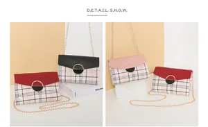 Detail view of stylish color-block plaid crossbody bags with gold chain straps and metal buckles
