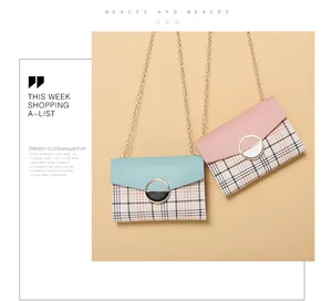 Close-up of mint green and pink flap crossbody bags with plaid pattern and gold chain
