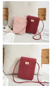 Vertical phone bags in pink and wine red featuring scalloped edges and gold metal twist locks